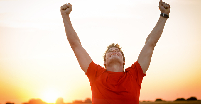 Joyful man with arms in the air